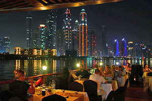 Dhow cruise with dinner and evening views of Old Dubai's historic landmarks together with new structures of the Creek